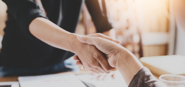 shaking hands across the table