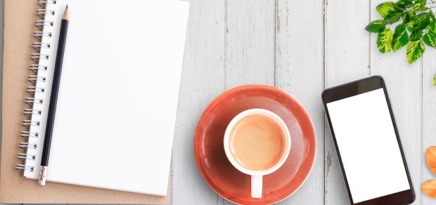 notepad, coffee cup, and cell phone